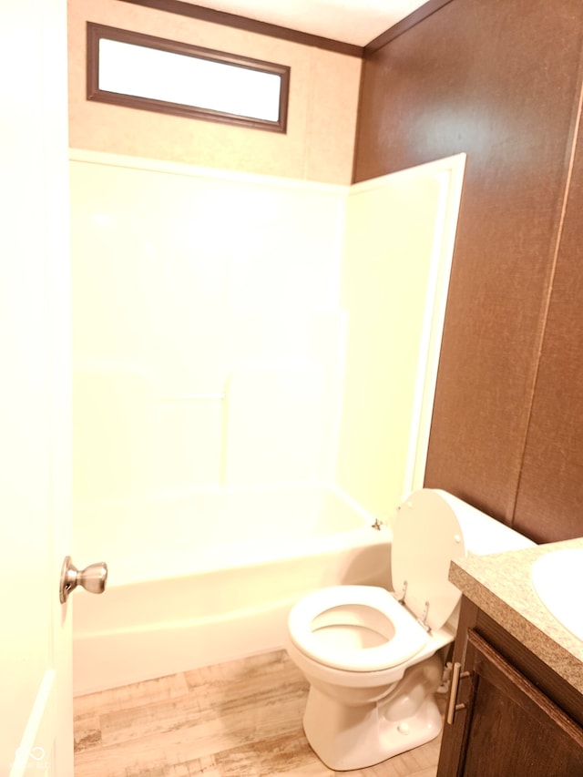 full bathroom with vanity, toilet, hardwood / wood-style floors, and shower / bathing tub combination