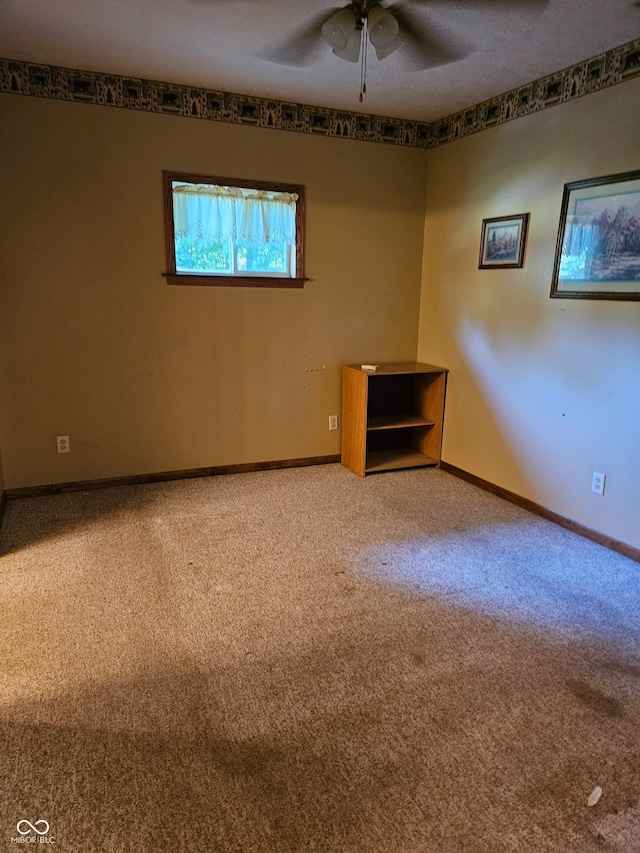 spare room with ceiling fan, carpet, and a textured ceiling