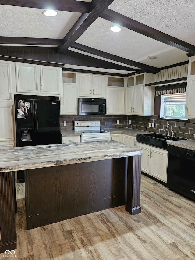 kitchen featuring black appliances, white cabinetry, and light hardwood / wood-style flooring