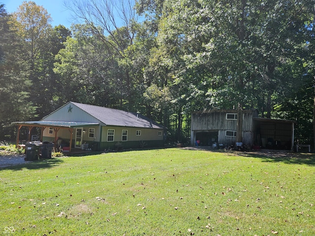 view of yard with a carport and a porch