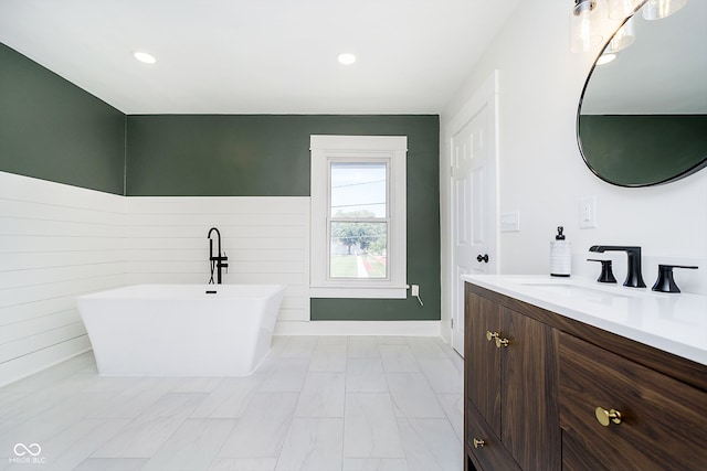 bathroom with vanity and a bath