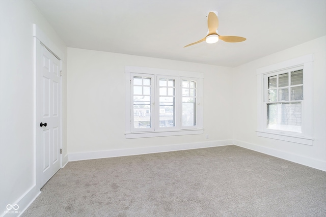 carpeted empty room featuring a healthy amount of sunlight and ceiling fan