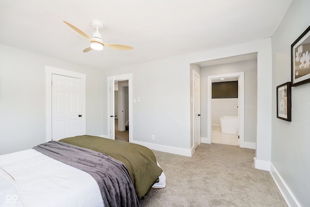 carpeted bedroom with ensuite bath and ceiling fan