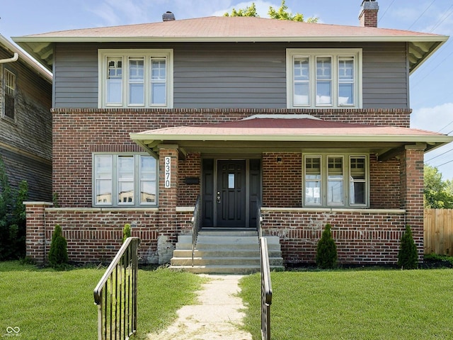 view of front of property featuring covered porch and a front lawn