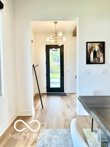 entryway featuring a notable chandelier and light hardwood / wood-style floors