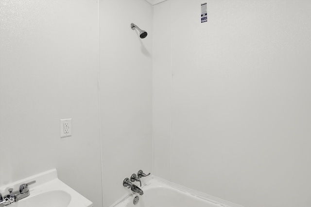 bathroom featuring sink and bathing tub / shower combination