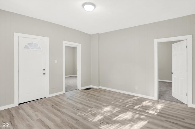 spare room featuring wood-type flooring