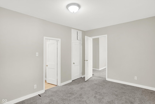 unfurnished bedroom with light colored carpet