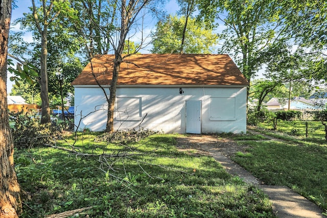 view of outbuilding with a yard