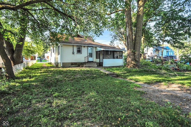 rear view of property featuring a yard