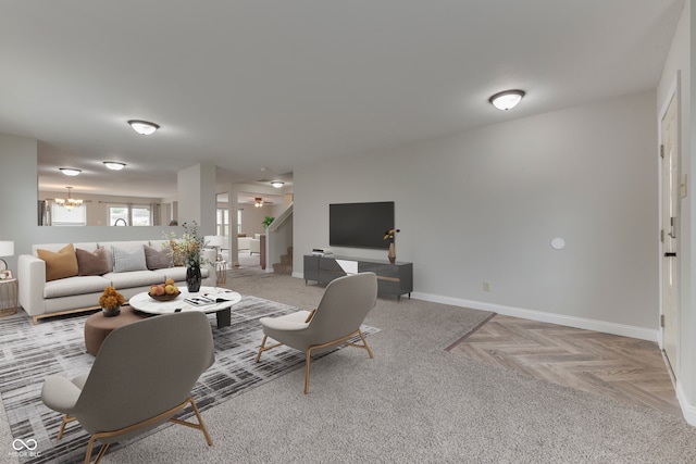 living room with a notable chandelier and light parquet floors