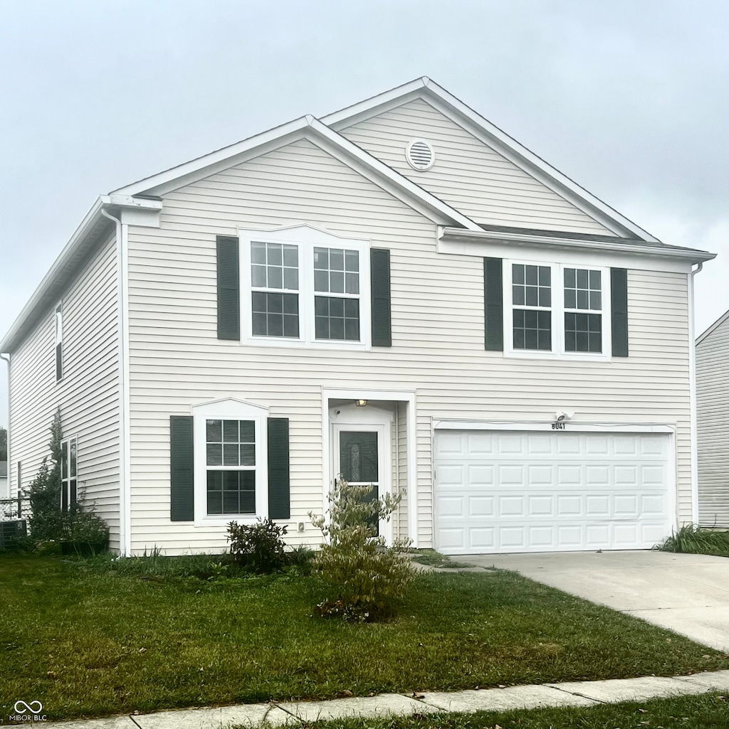 view of front facade with a garage and a front yard