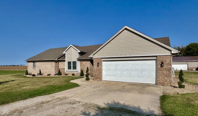 single story home featuring a garage and a front yard