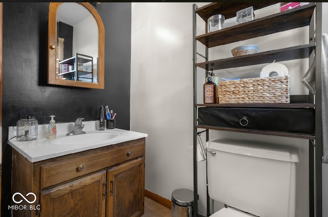 bathroom featuring toilet and vanity