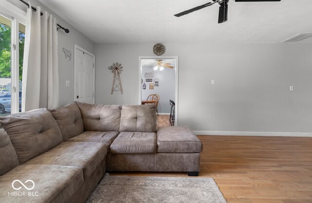 living room featuring hardwood / wood-style flooring and ceiling fan