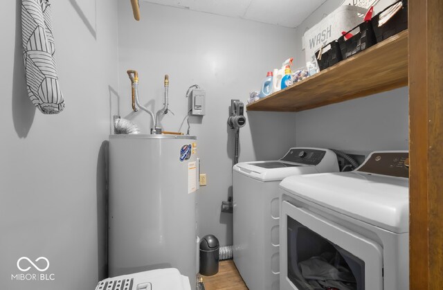 clothes washing area with water heater and washer and clothes dryer