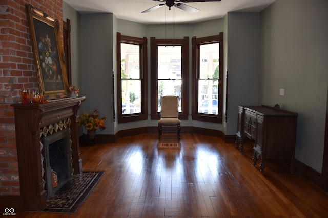 unfurnished living room with ceiling fan and dark hardwood / wood-style floors