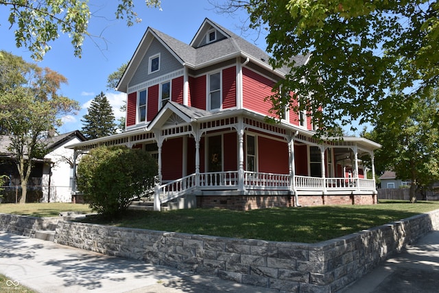 view of front of home with a front yard and a porch