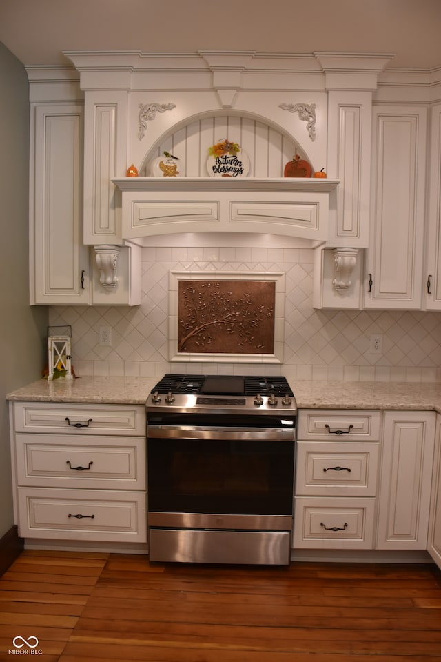 kitchen featuring light stone counters, stainless steel range, and dark hardwood / wood-style floors