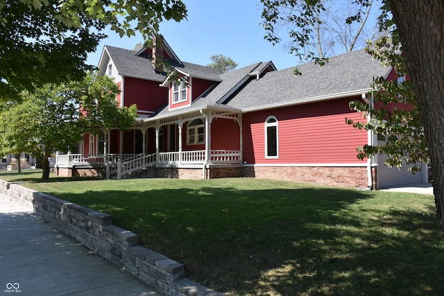 victorian house with a garage, a front yard, and covered porch