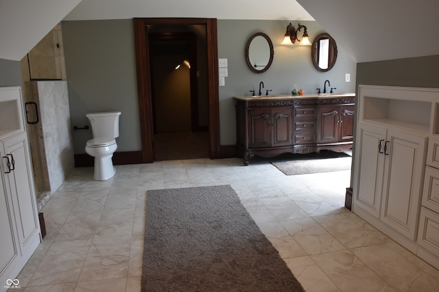 bathroom featuring vanity, toilet, a chandelier, and vaulted ceiling