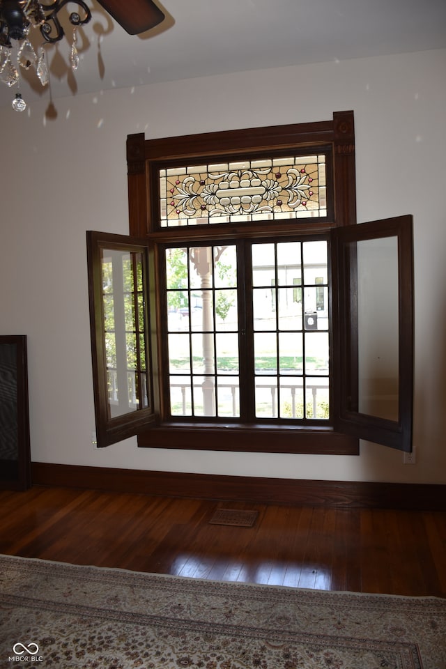 entryway with dark hardwood / wood-style floors and a healthy amount of sunlight