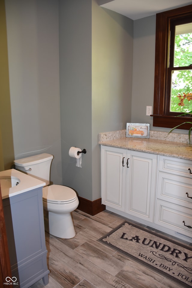 bathroom featuring vanity, hardwood / wood-style floors, and toilet