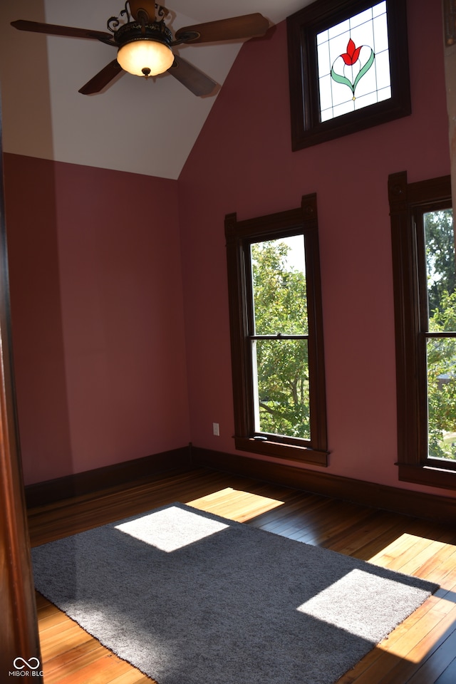 spare room featuring ceiling fan, wood-type flooring, and high vaulted ceiling