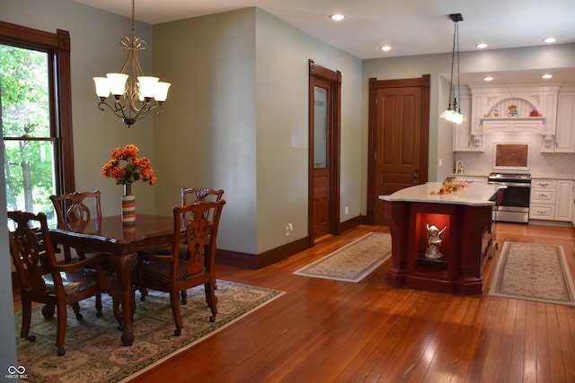 dining room featuring hardwood / wood-style floors and a chandelier