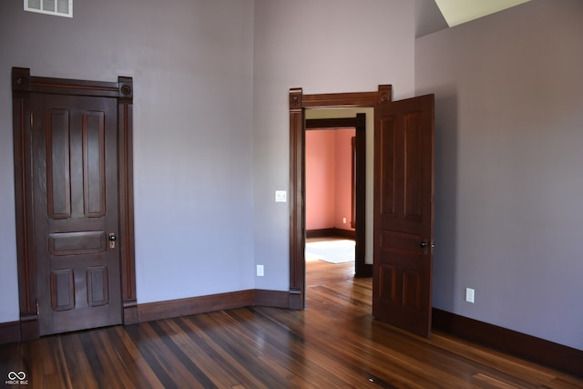 spare room featuring dark wood-type flooring