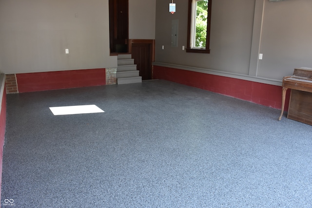 unfurnished living room featuring electric panel