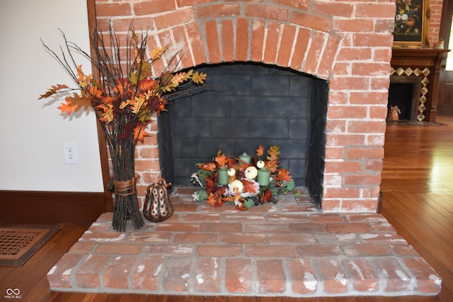 room details with hardwood / wood-style flooring and a fireplace