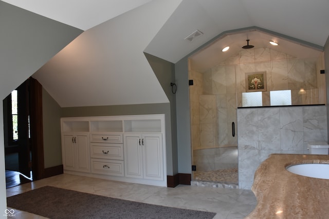 bathroom featuring tile walls, an enclosed shower, lofted ceiling, vanity, and toilet