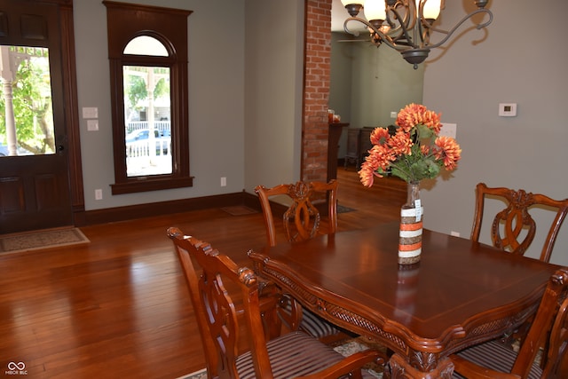 dining room with a notable chandelier and dark wood-type flooring