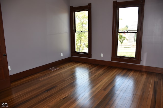 spare room with dark wood-type flooring