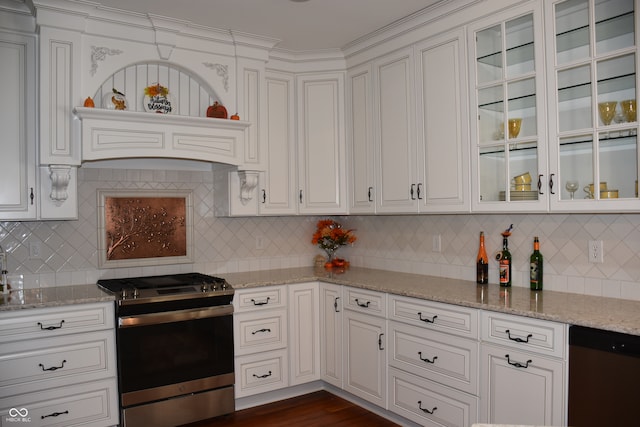 kitchen featuring appliances with stainless steel finishes, white cabinetry, light stone counters, and tasteful backsplash