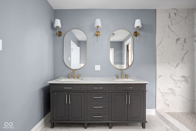 bathroom featuring tiled shower and vanity