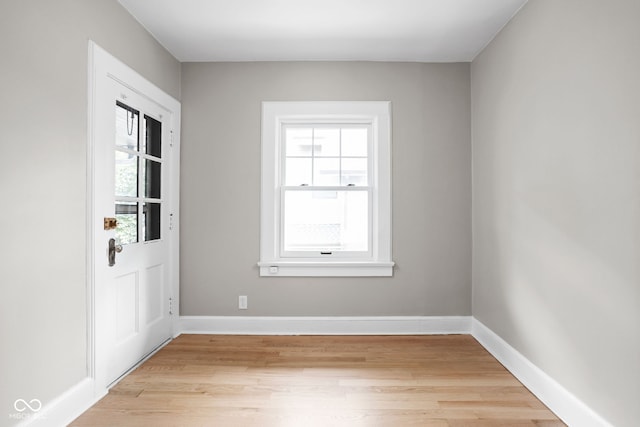 empty room with baseboards and light wood-style floors