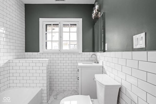 full bathroom featuring tile walls, separate shower and tub, toilet, and vanity