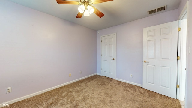 unfurnished bedroom with ceiling fan and carpet floors