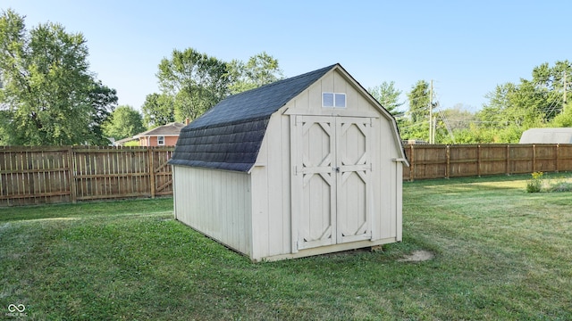 view of outdoor structure featuring a lawn