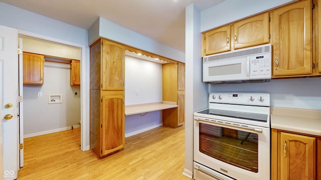 kitchen featuring light hardwood / wood-style flooring and white appliances