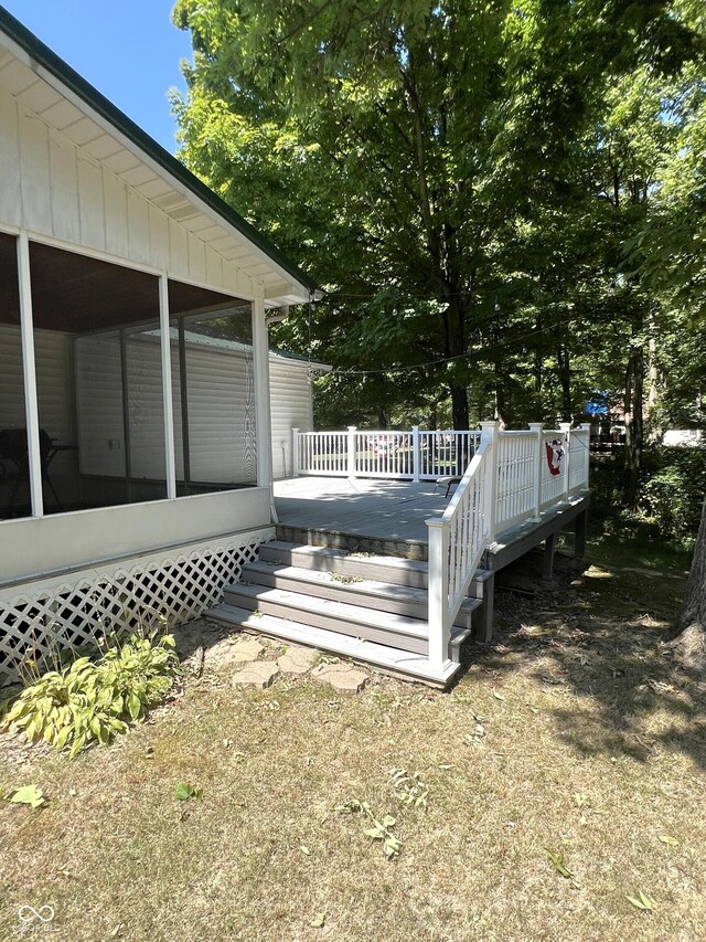 exterior space with a sunroom and a deck