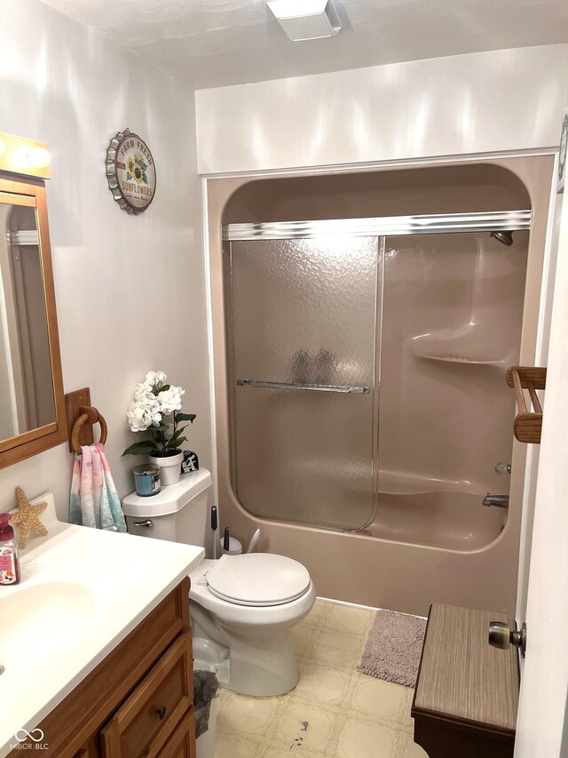 full bathroom featuring toilet, combined bath / shower with glass door, and vanity