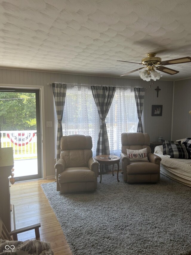 living room featuring hardwood / wood-style flooring and ceiling fan