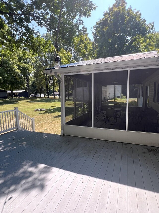 wooden terrace featuring a lawn