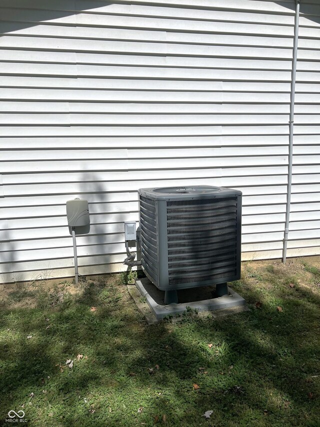 exterior details featuring a wood stove and central AC