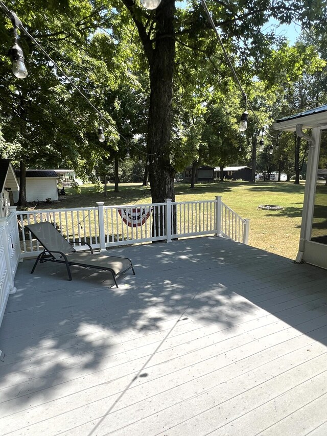 wooden terrace with a lawn