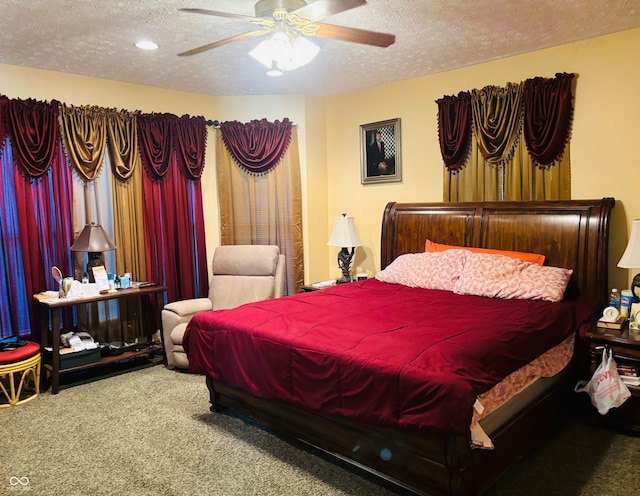 bedroom with ceiling fan, carpet floors, and a textured ceiling