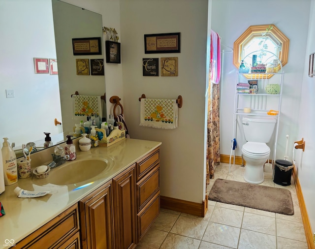 bathroom with tile patterned flooring, vanity, and toilet